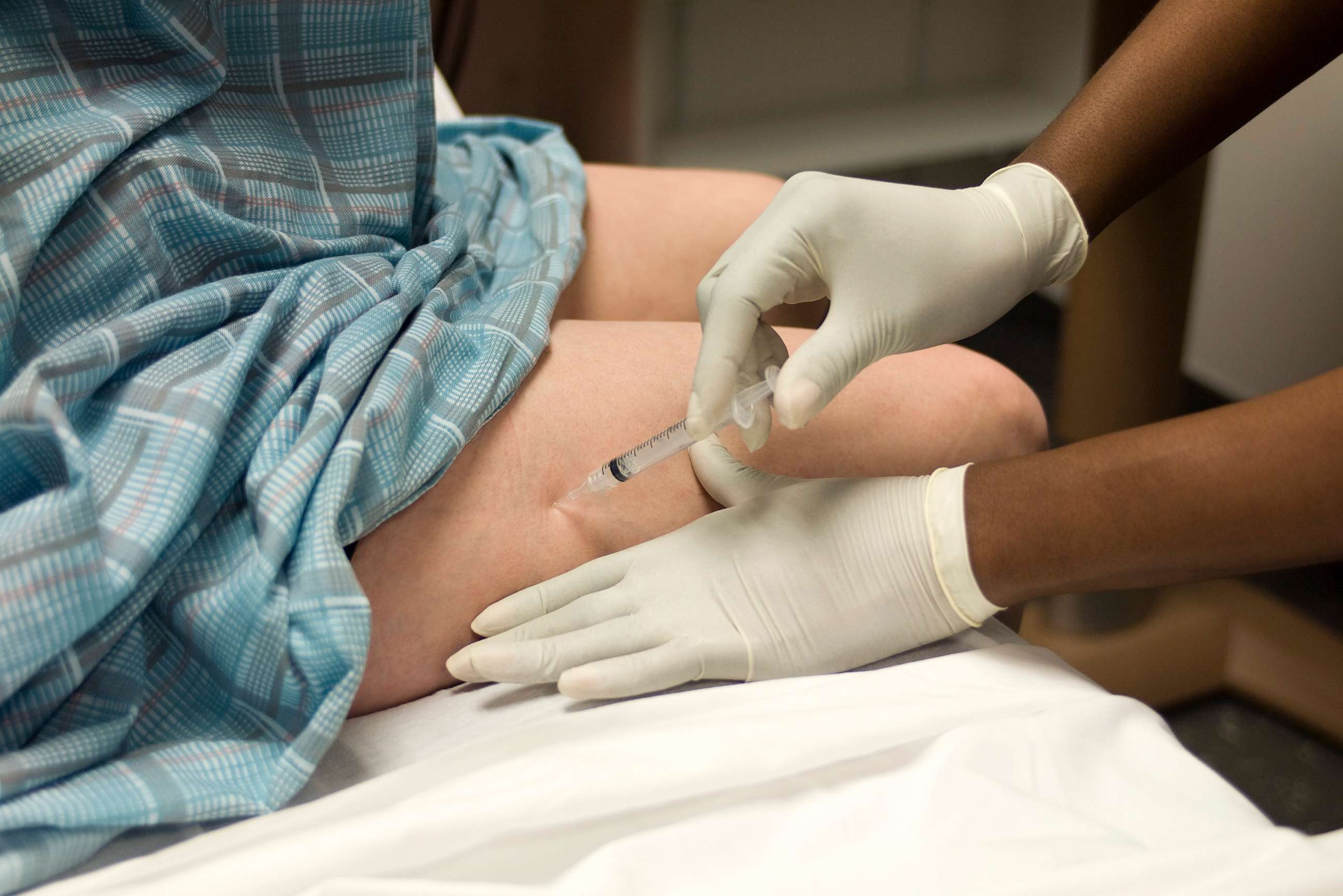 PHOTO: patient getting an injection in the leg.