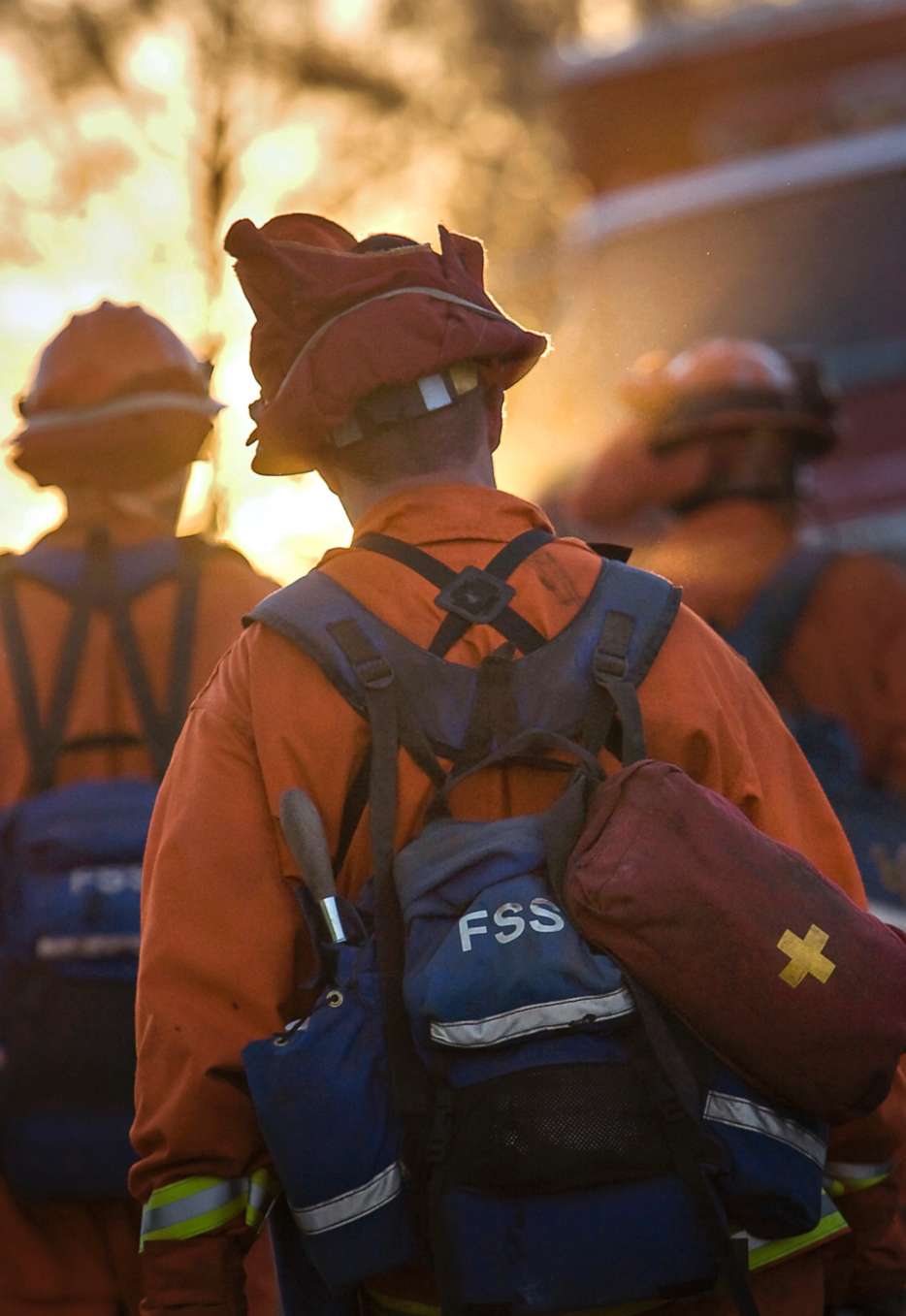 PHOTO: A 2007 file photo of an inmate volunteer firefighter member of the "Angels in Orange"? marches into a California wildfire wearing the signature orange uniform and carrying heavy gear. 