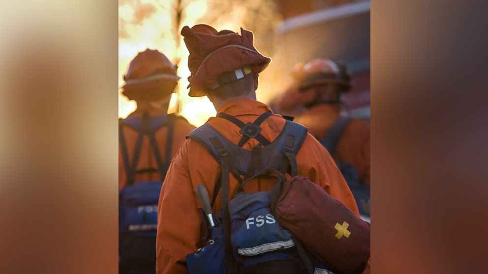 PHOTO: A 2007 file photo of an inmate volunteer firefighter member of the "Angels in Orange"? marches into a California wildfire wearing the signature orange uniform and carrying heavy gear. 
