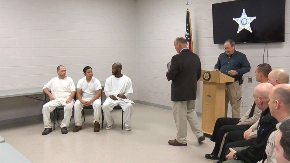 PHOTO: Inmates who rushed to aid the North Carolina officer overseeing them pick up trash when he collapsed on a road are awarded certificates of commendation.