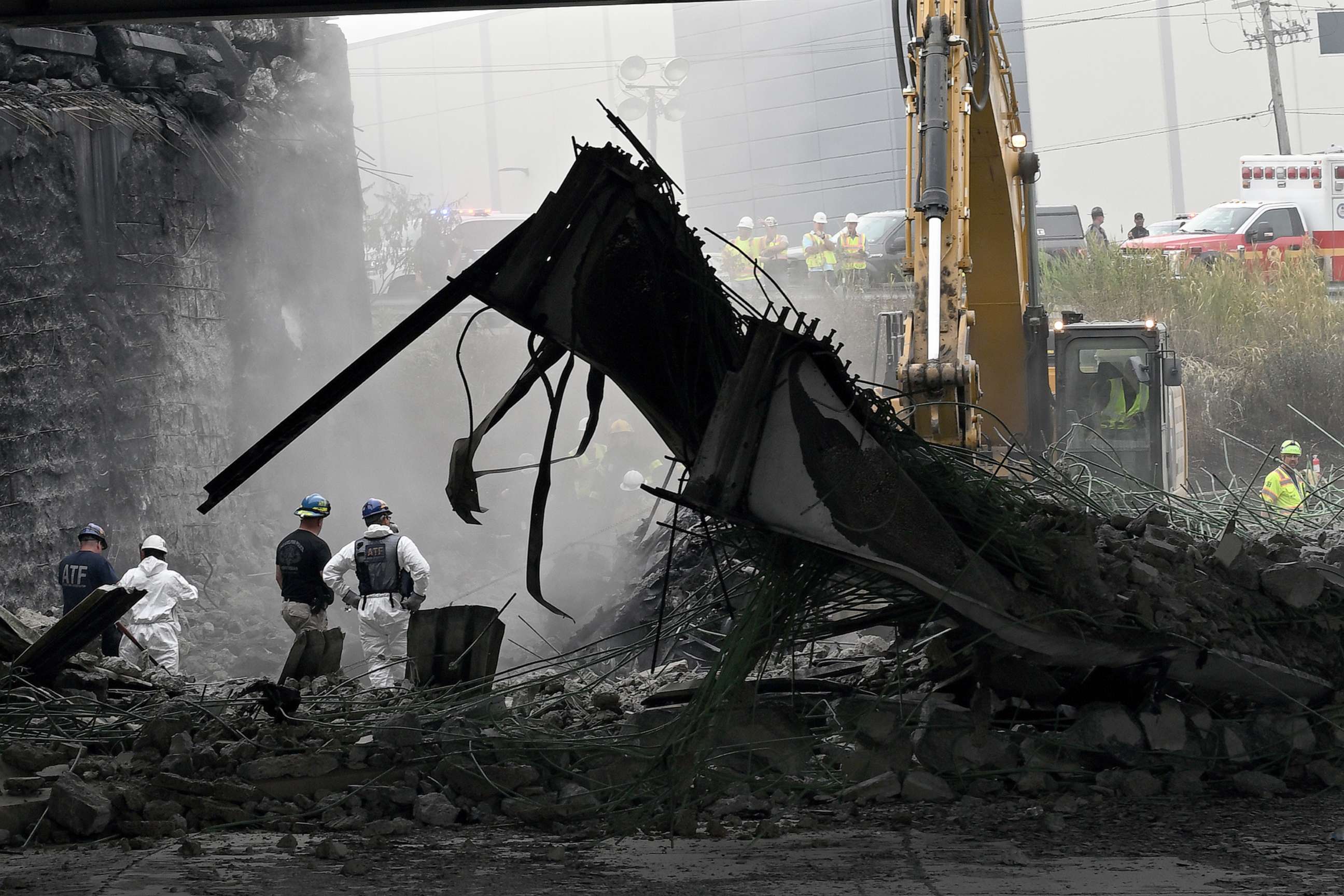 PHOTO: Workers inspect and clear debris from a section of the bridge that collapsed on Interstate 95 after an oil tanker explosion on June 12, 2023 in Philadelphia.