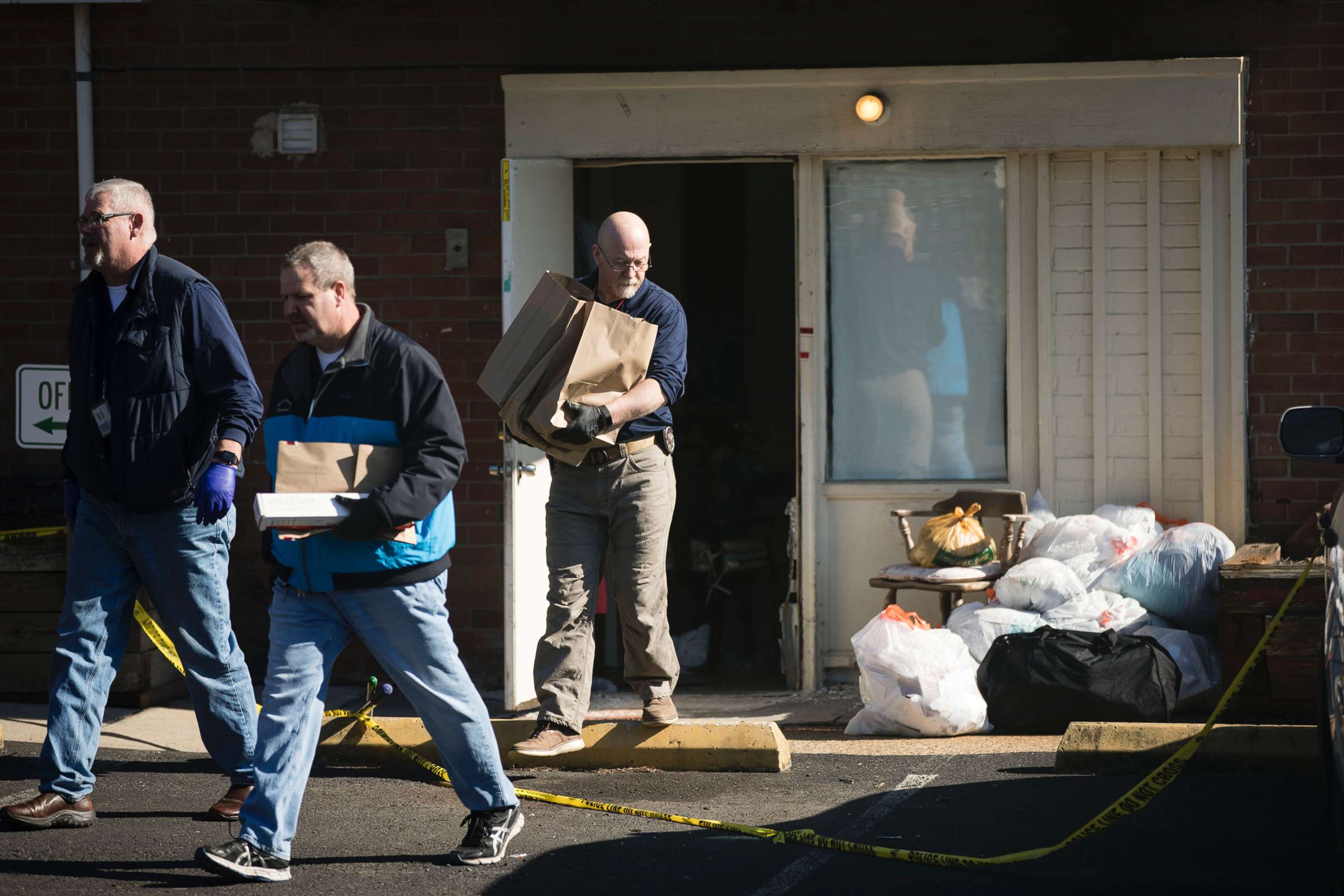 PHOTO: Investigators carry out items from the Robert Morris Apartments in Morrisville, Pa., Feb. 26, 2019.