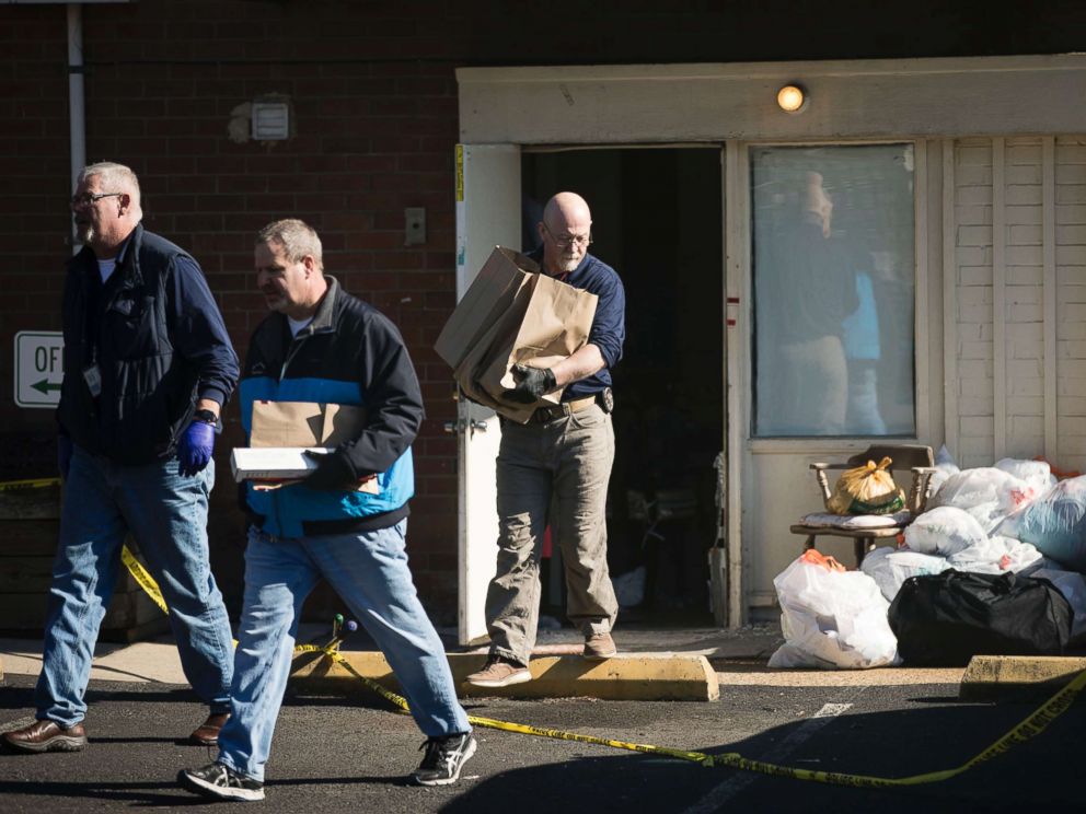 PHOTO: Investigators carry out items from the Robert Morris Apartments in Morrisville, Pa., Feb. 26, 2019.