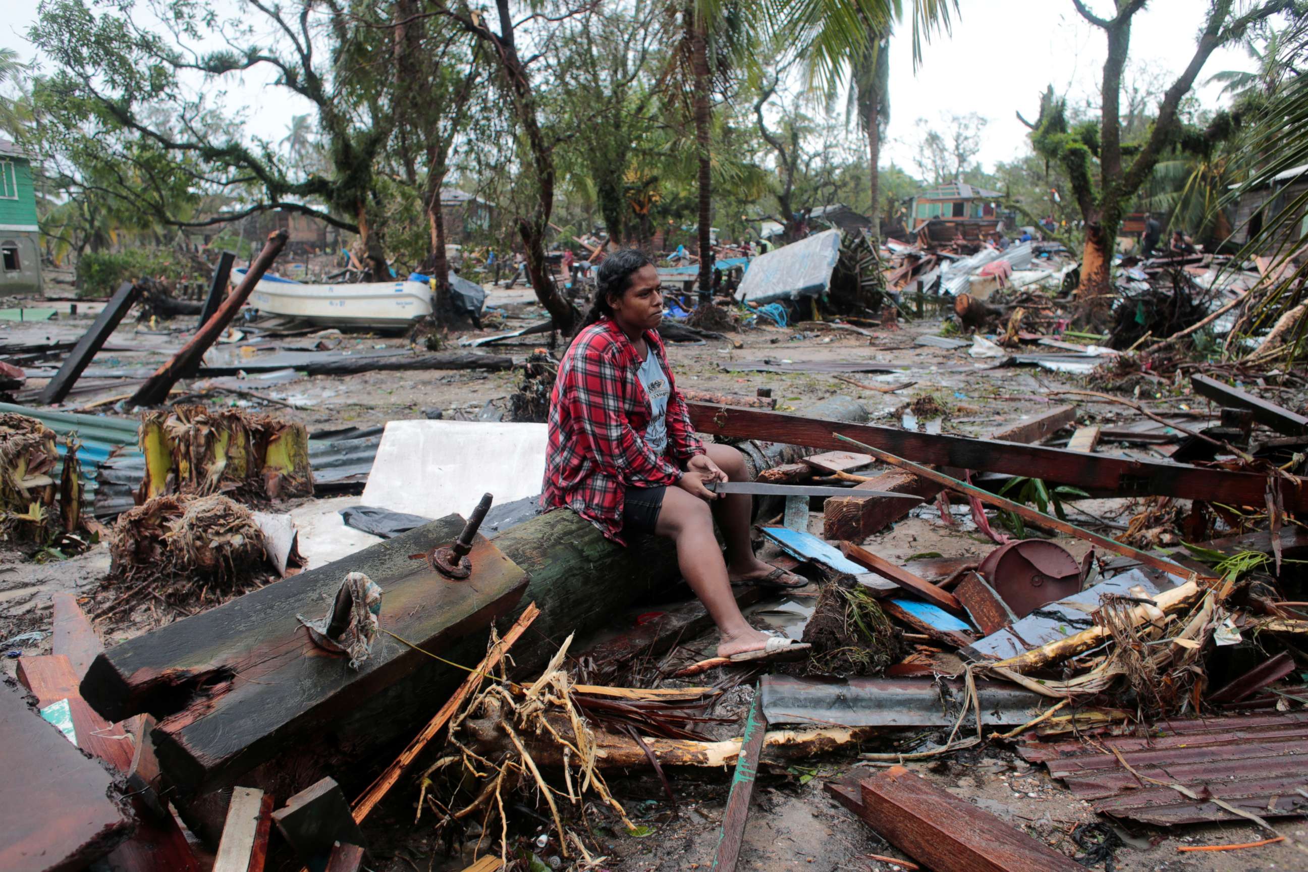 PHOTO: A woman sits on a toppled energy pole while contemplating her house destroyed in the passing of Hurricane Iota, in Puerto Cabezas, Nicaragua, Nov. 17, 2020.