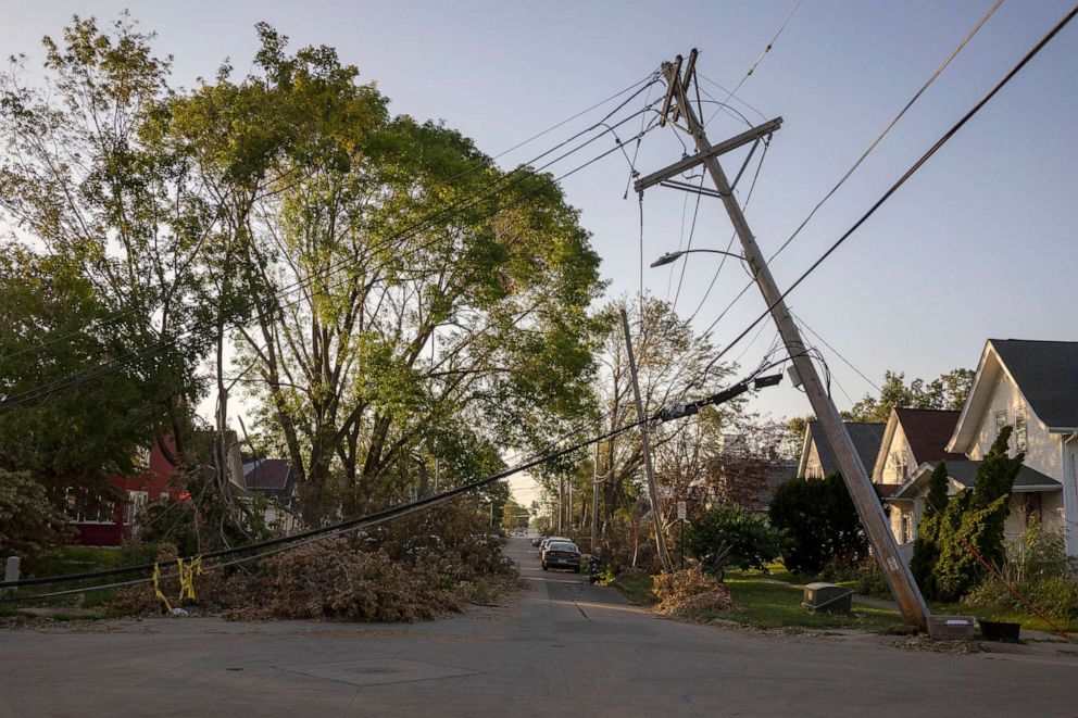 PHOTO: A downed power line leans over a street in Cedar Rapids, Iowa, Aug. 16, 2020. A rare Derecho storm battered large sections of Cedar Rapids leaving people homeless and without power. 