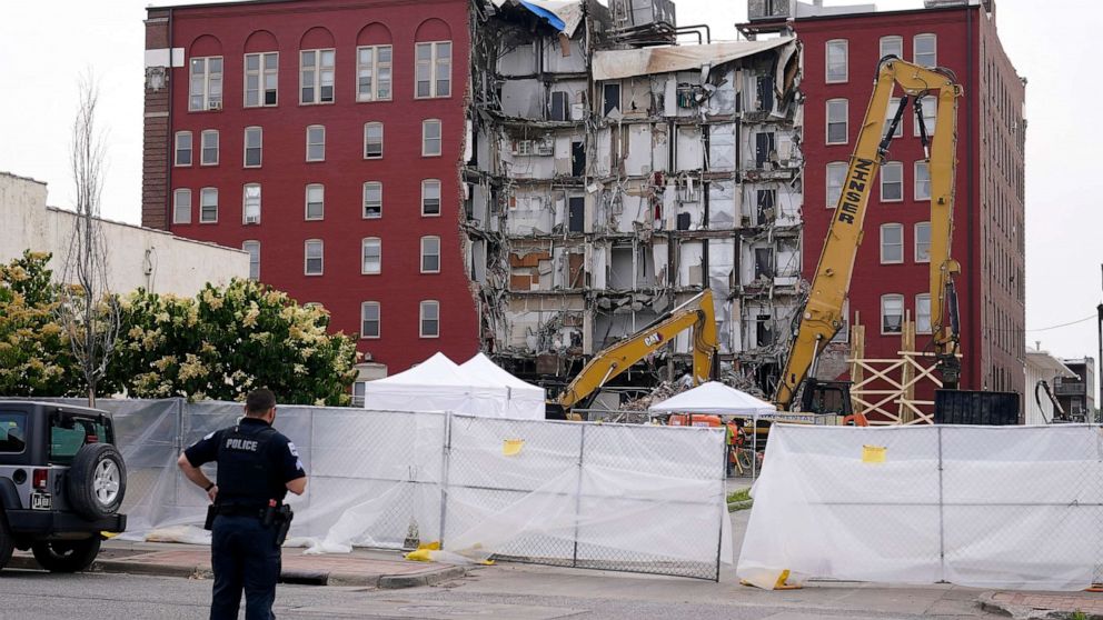 PHOTO: A police officer stands at the site of a collapsed apartment building, June 5, 2023, in Davenport, Iowa.