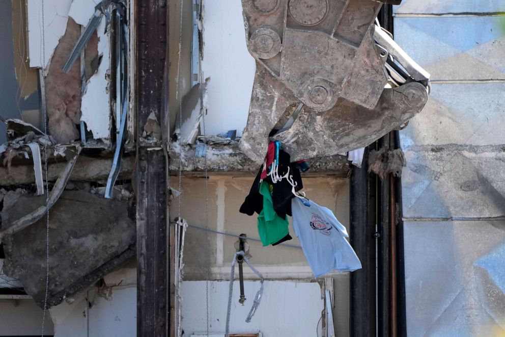 PHOTO: Clothing is removed from a closet during demolition at the site of a building collapse, June 12, 2023, in Davenport, Iowa.