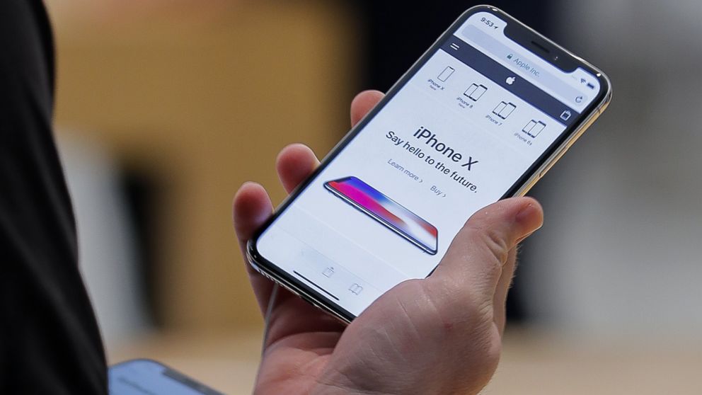 A customer examines the newly released iPhone X at an Apple Store in the Perimeter Mall in Atlanta, Nov. 3, 2017. 