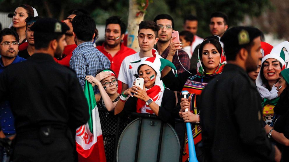 PHOTO: FILE - Iranian football supporters arrive with vuvuzelas and dressed in their national team's colours and paraphernalia outside Azadi stadium in the capital Tehran on June 20, 2018, to attend a screening of the Russia 2018 World Cup Group B.