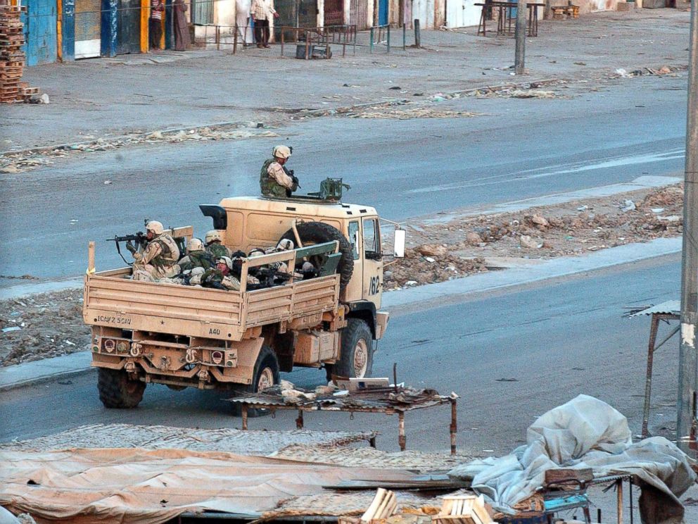 PHOTO: U.S. troops patrol the deserted streets of the sprawling Shia slum of Sadr City at sunset after a day of tense clashes across the country with supporters of controversial Shia cleric Moqtada al-Sadr, April 4, 2004, in Sadr City, Iraq.