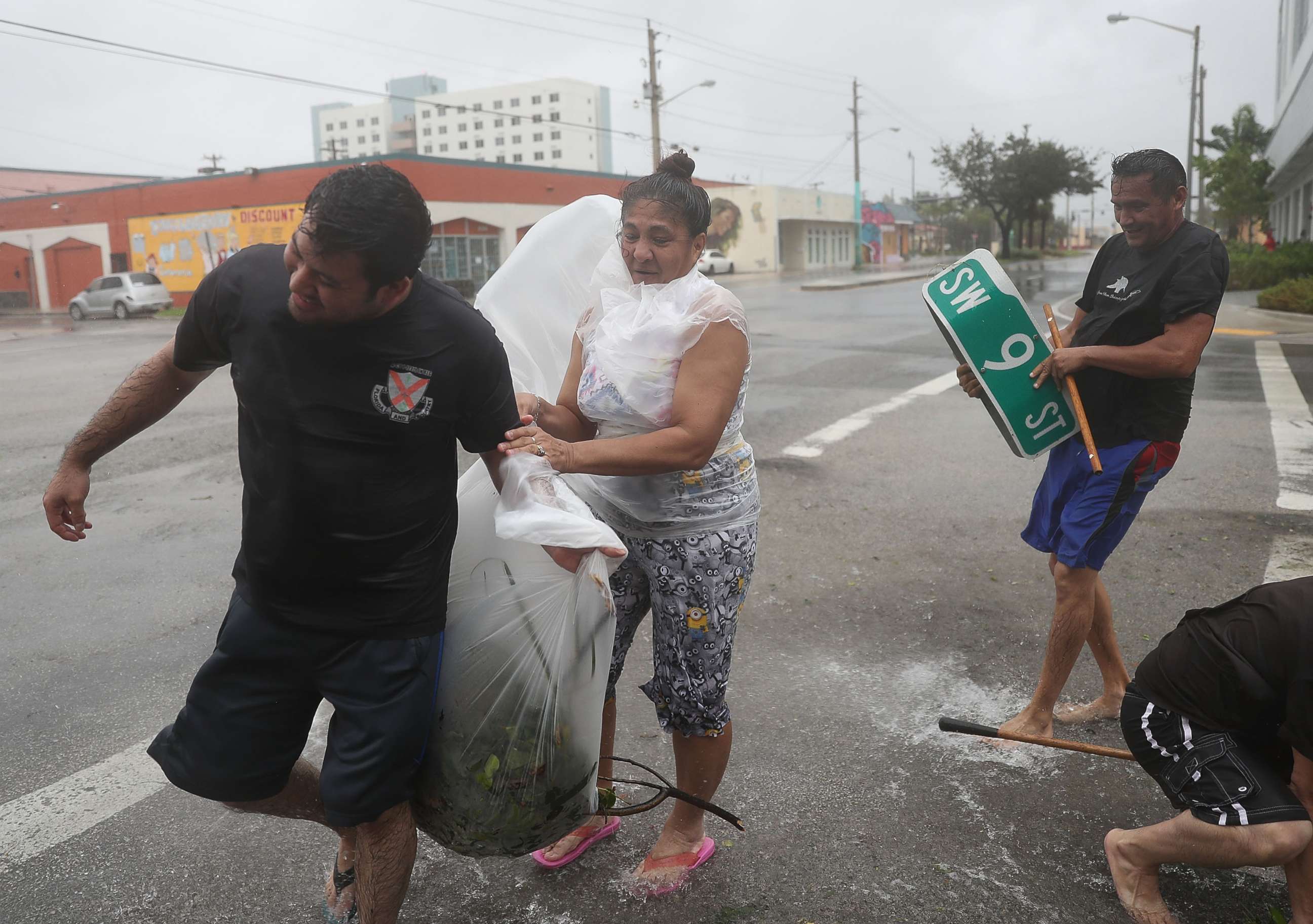 PHOTO: People clear debris out of a drainage ditch in an attempt to keep the area from flooding as Hurricane Irma passes through on Sept. 10, 2017 in Miami.