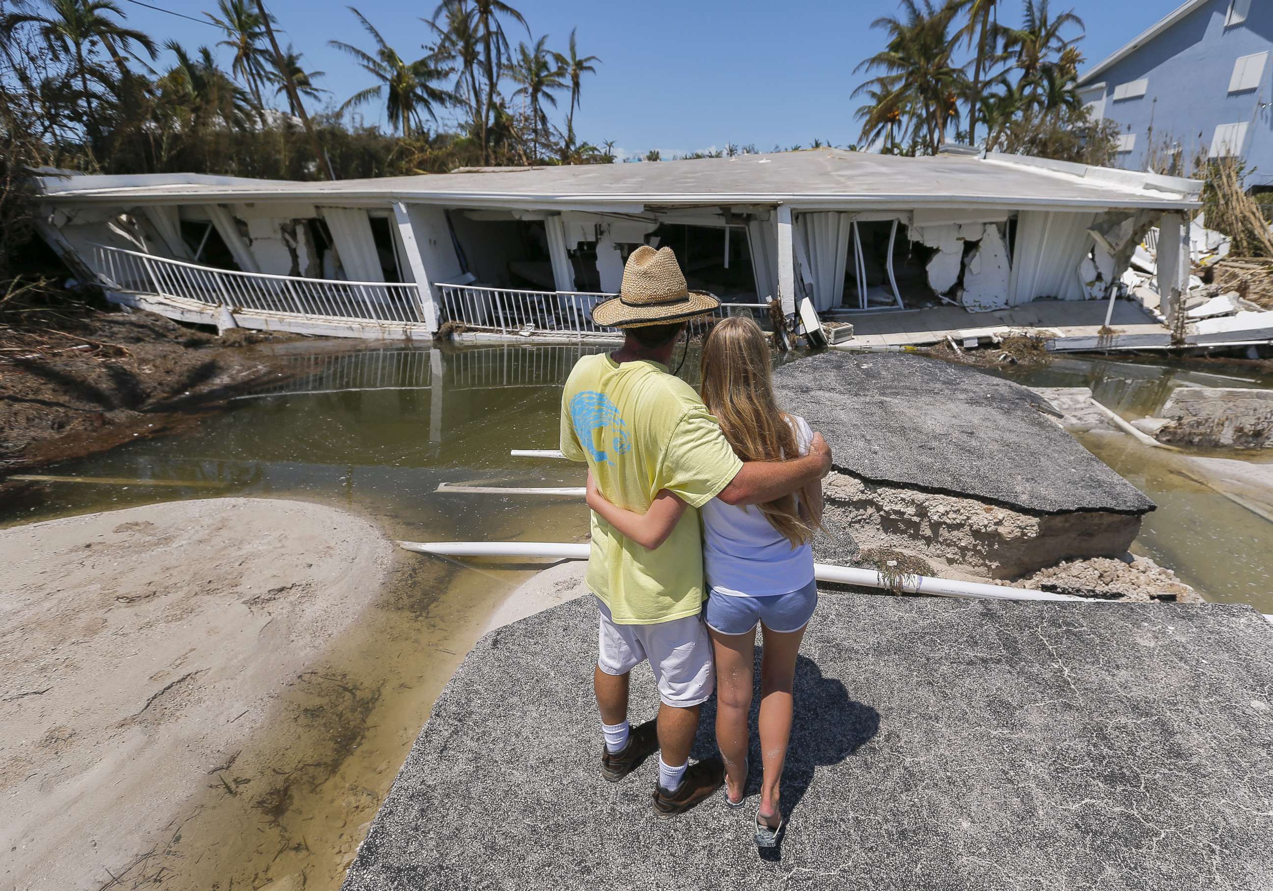 PHOTO: Mike Gilbert hugs his daughter Brooke while looking at a destroyed three-story condominium building after Hurricane Irma struck the Florida Keys in Islamorada, Fla., Sept. 12, 2017. The Gilbert family owns a unit in the building.