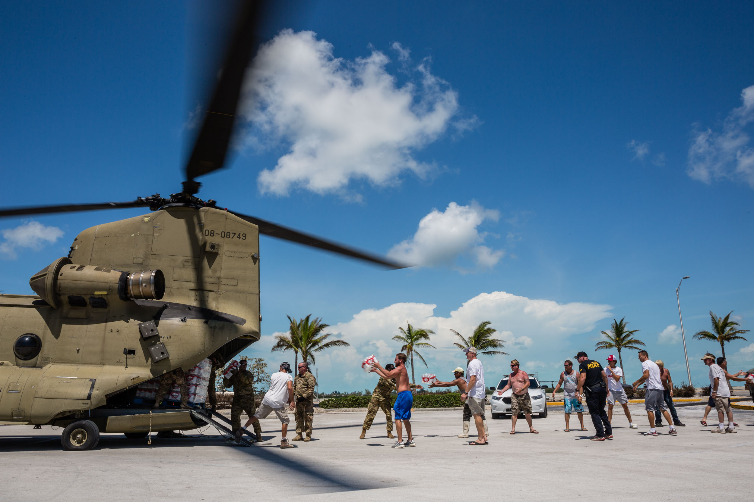 PHOTO: Soldiers with the Florida National Guard deliver food and water by a Chinook cargo helicopter that landed in a shopping center parking lot in Key West, Fla., Sept. 13, 2017.