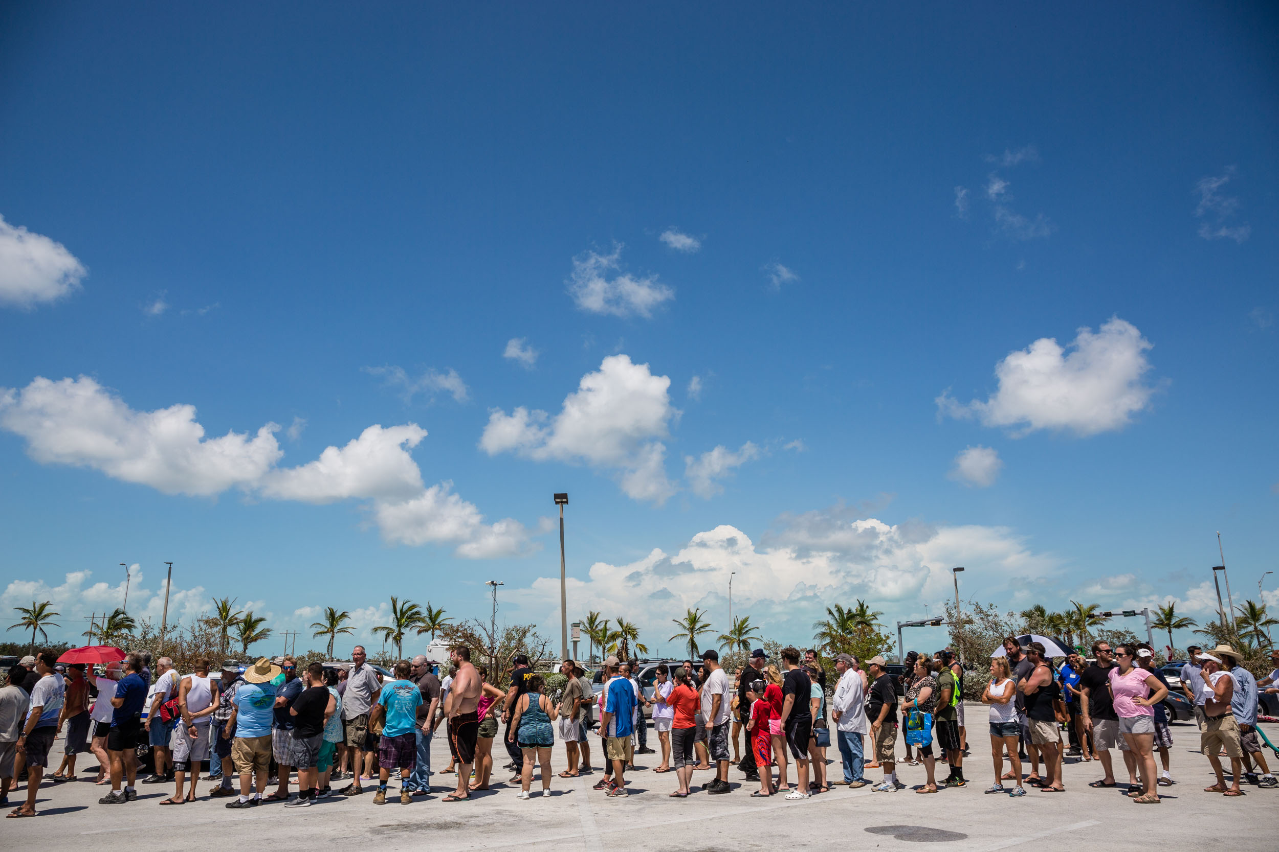 PHOTO: Residents line up for food and water relief supplies in a shopping center parking lot in Key West, Fla., Sept. 13, 2017.