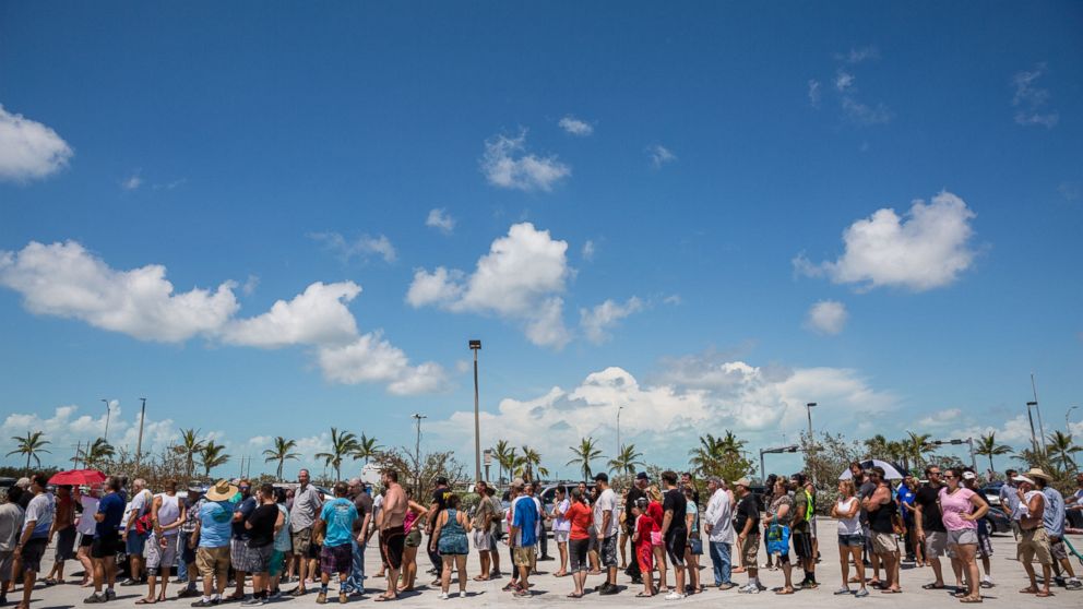 PHOTO: Residents line up for food and water relief supplies in a shopping center parking lot in Key West, Fla., Sept. 13, 2017.