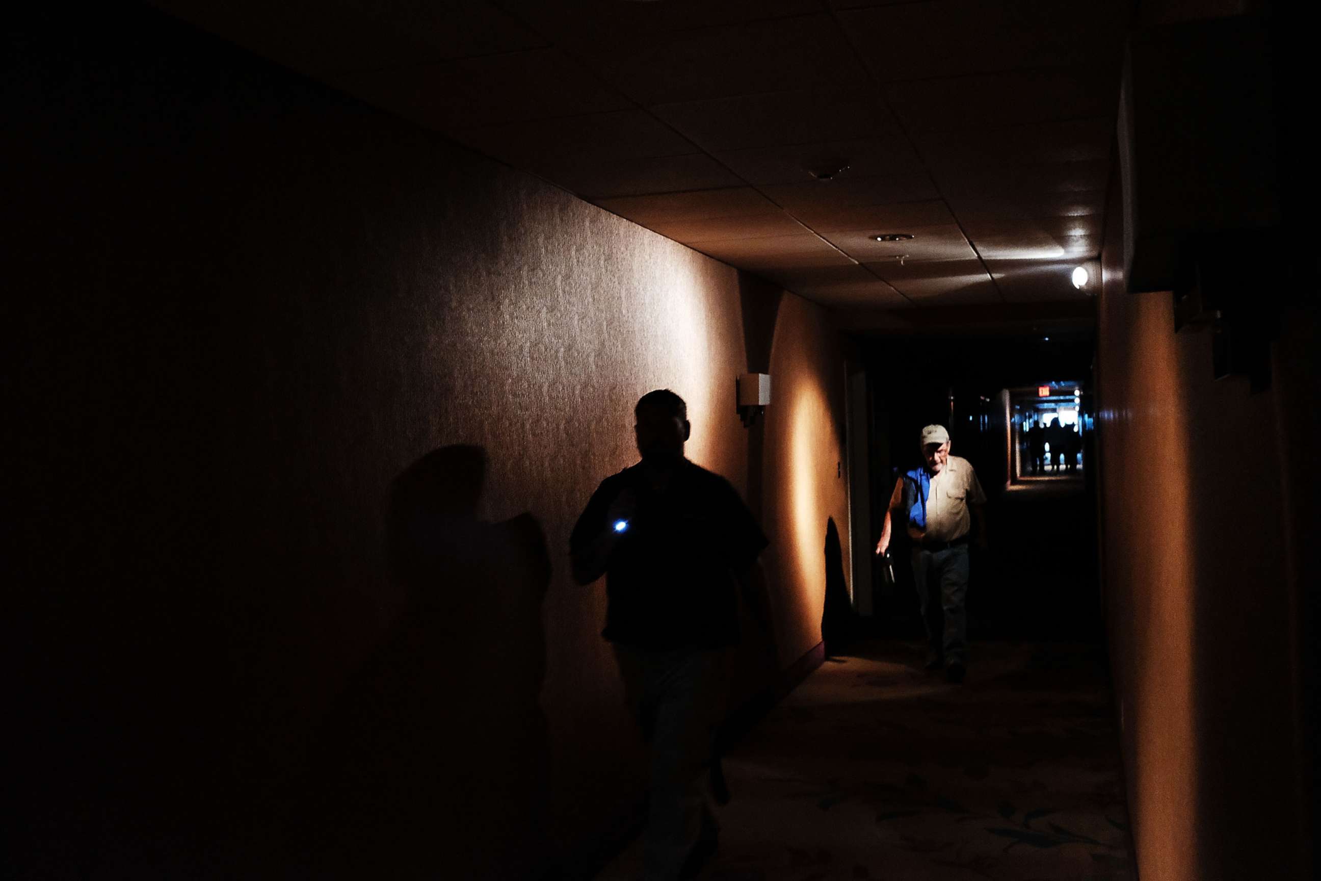 PHOTO: Hotel guests walk through dark hallways after the electricity was lost as Hurricane Irma arrives into southwest Florida, Sept. 10, 2017 in Fort Myers, Florida.  