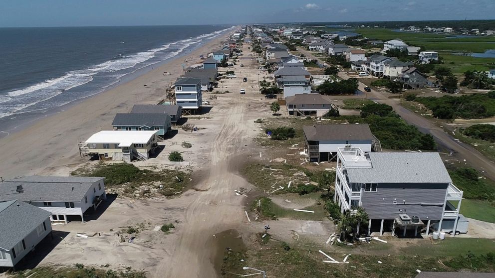 PHOTO: Oak Island sustained wind and flood damage caused by Hurricane Isaias leaving the streets strewn with debris and covered with more than a foot of sand in areas close to the beach, Aug. 4, 2020, in North Carolina. 