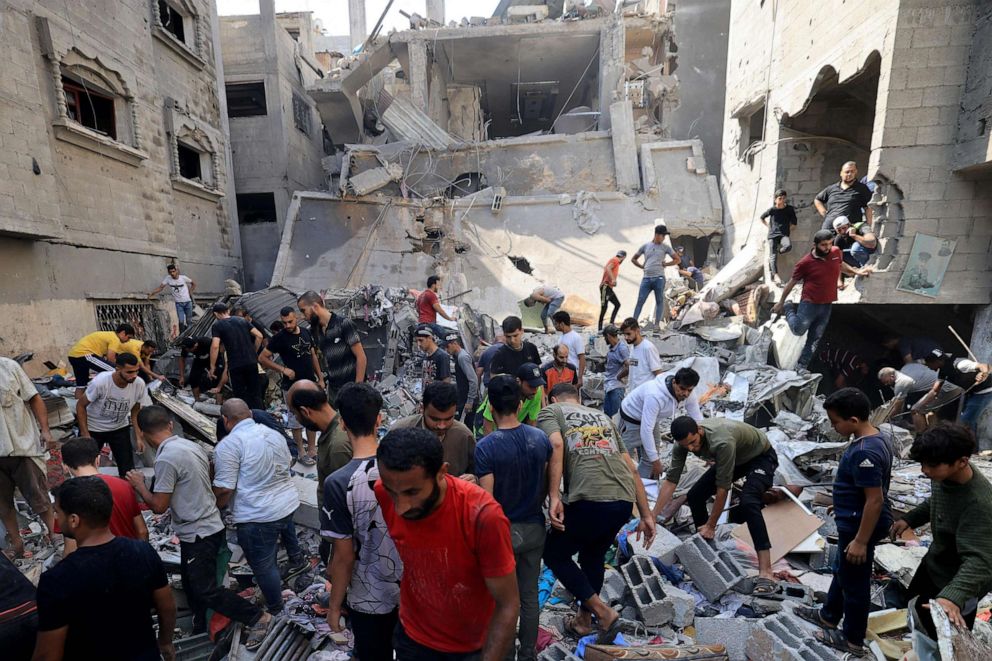 PHOTO: Palestinians look for survivors amid the rubble of a building hit in an Israeli air strike in Khan Yunis on the southern Gaza Strip, Oct. 24, 2023.