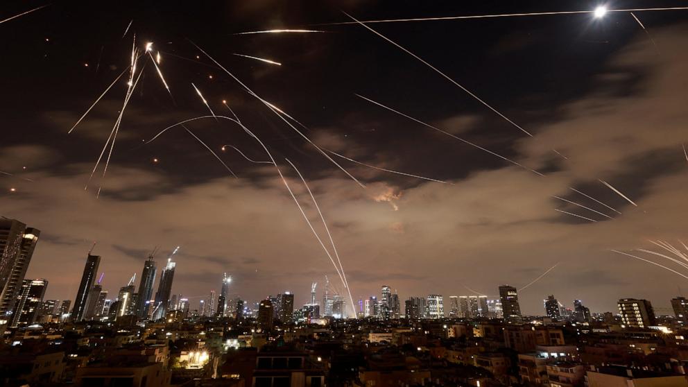 PHOTO: Israeli air defence systems are activated to intercept Iranian missiles over the Israeli city of Tel Aviv amid a fresh barrage of Iranian rockets, June 16, 2025.