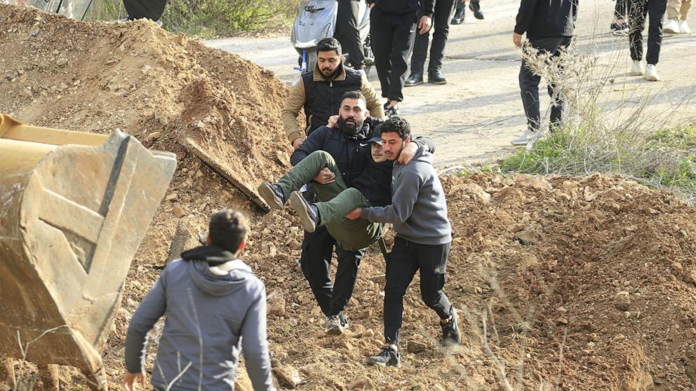 PHOTO: People carry an injured person on a road leading to their village after a confrontation with Israeli soldiers positioned in Meiss al-Jabal, Marjayoun District, southern Lebanon, Jan. 26, 2025. 