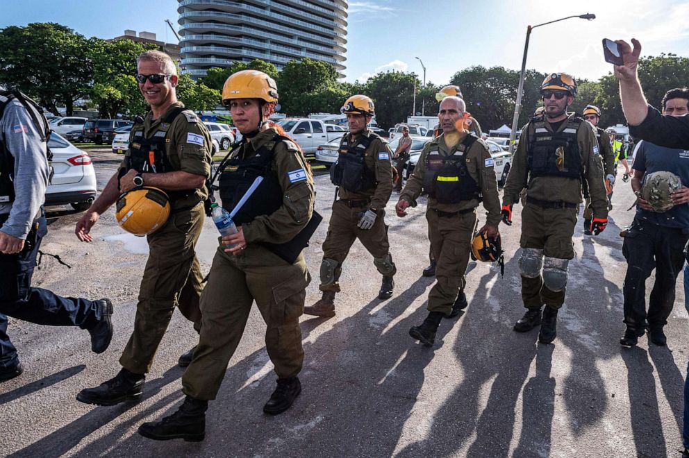 PHOTO: MMembers of the Israel Rescuers delegation gather upon their arrival in the area near the partially collapsed 12-story Champlain Towers South condo building in the city of Surfside, Florida, June 27, 2021.