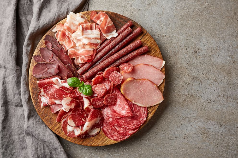 PHOTO: Smoked meat with prosciutto, salami, bacon, pork chops, cheese and olives sits on a plate.
