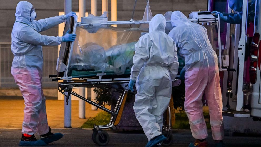 PHOTO: Medical workers move a patient under intensive care into the newly built Columbus Covid 2 temporary hospital to fight the new coronavirus infection, on March 16, 2020 at the Gemelli hospital in Rome.