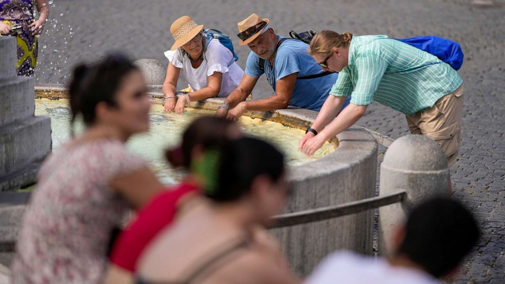 PHOTO: Tourists cool off at a fountain in Rome, July 22, 2023, as an intense heat wave reached Italy and much of Europe.