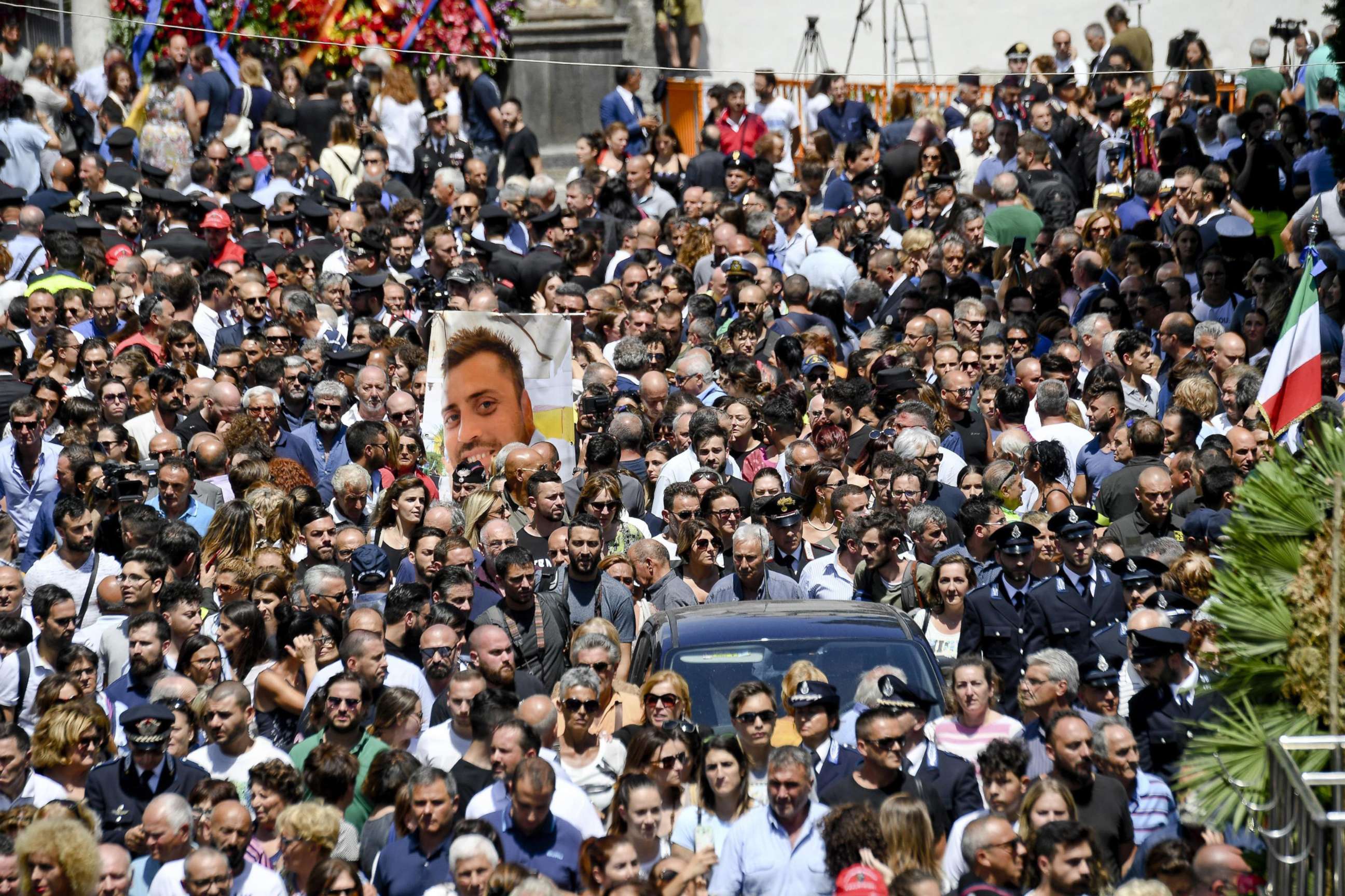 PHOTO: A photograph of Carabinieri officer Mario Cerciello Rega is carried during his funeral in his hometown of Somma Vesuviana in southern Italy, July 29, 2019.