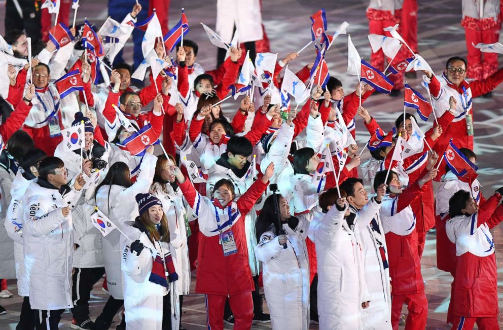 PHOTO: Unlike the unity that they showed in the opening ceremony, athletes of North Korea wore red jackets while South Korean athletes wore white jackets. They both carried their countries flags at the closing ceremony, Feb. 25, 2018. 