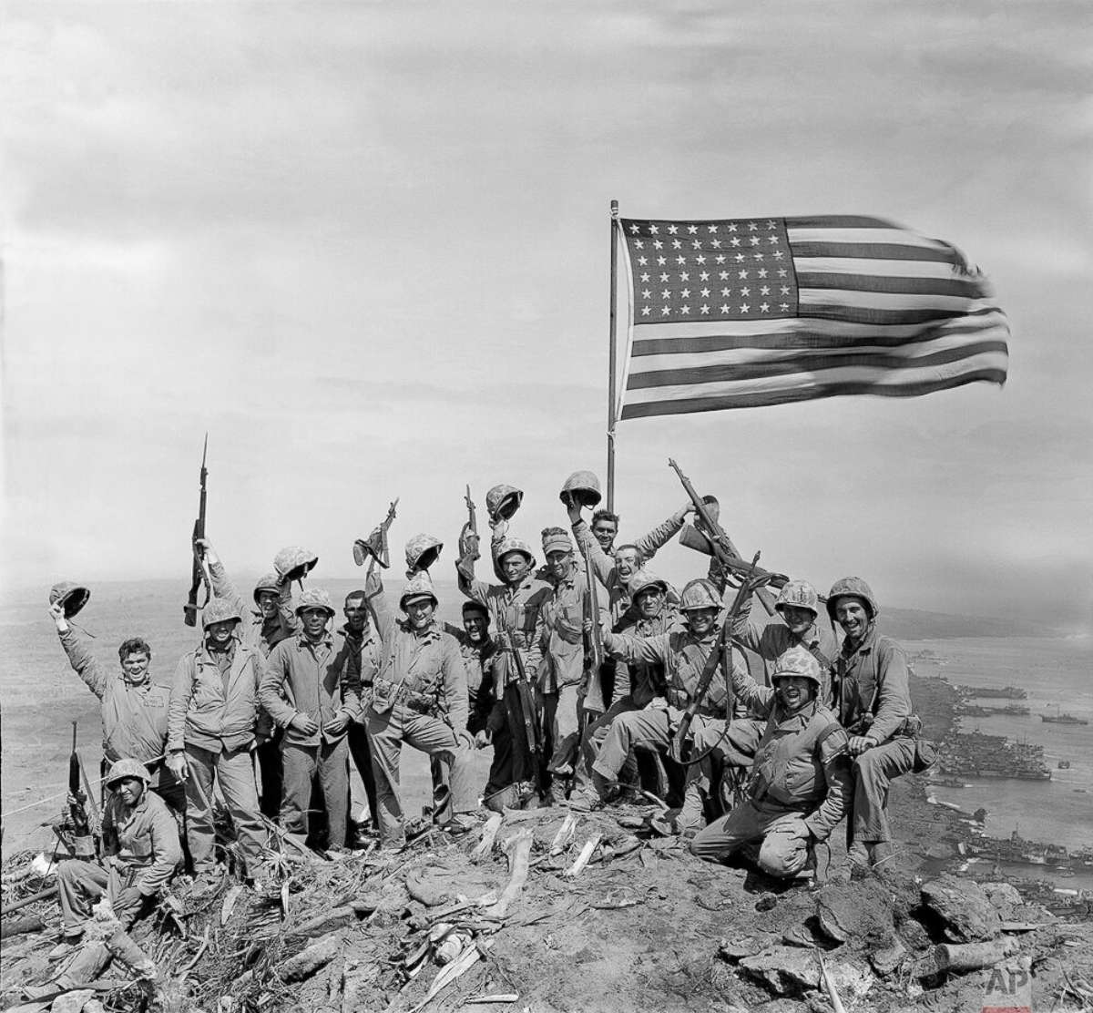 PHOTO: U.S. Marines of the 28th Regiment, fifth division, cheer and hold up their rifles after the second flag raising atop Mount Suribachi on Iwo Jima, a volcanic Japanese island, on Feb. 23, 1945 during World War II.