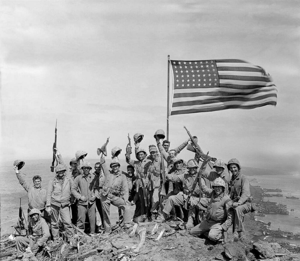 PHOTO: U.S. Marines of the 28th Regiment, fifth division, cheer and hold up their rifles after the second flag raising atop Mount Suribachi on Iwo Jima, a volcanic Japanese island, on Feb. 23, 1945 during World War II.