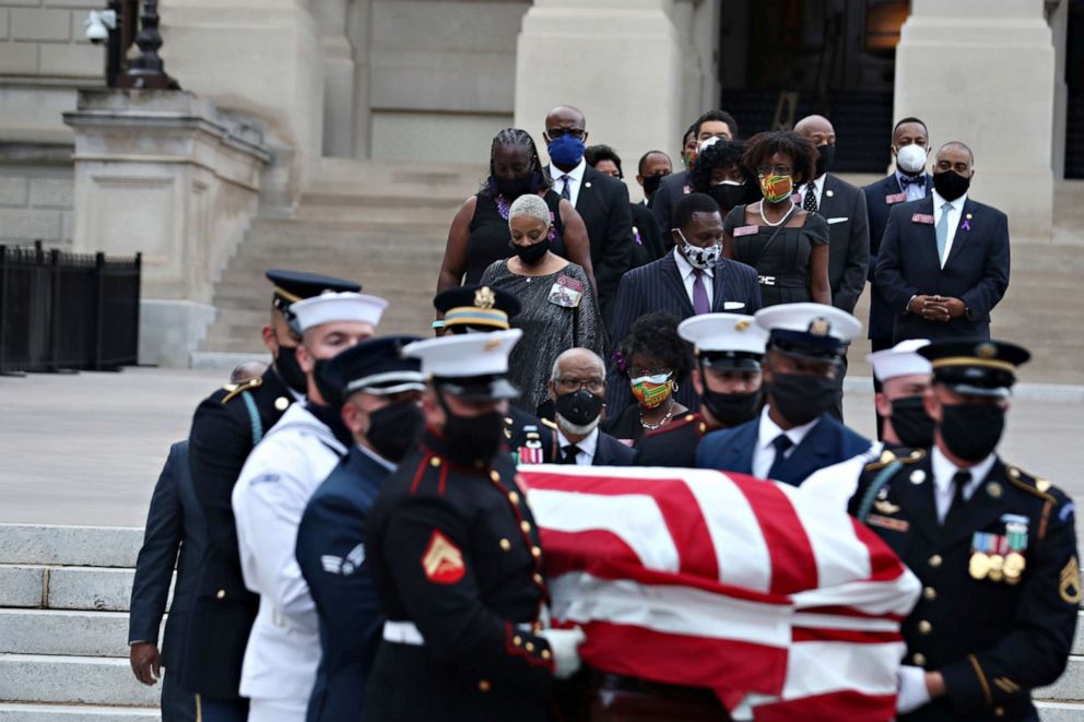 PHOTO: An honor guard, followed by members of Georgia's Black Caucus, carries the casket of late Congressman John Lewis from the Georgia State Capitol building en route to his funeral in Atlanta, July 30, 2020.