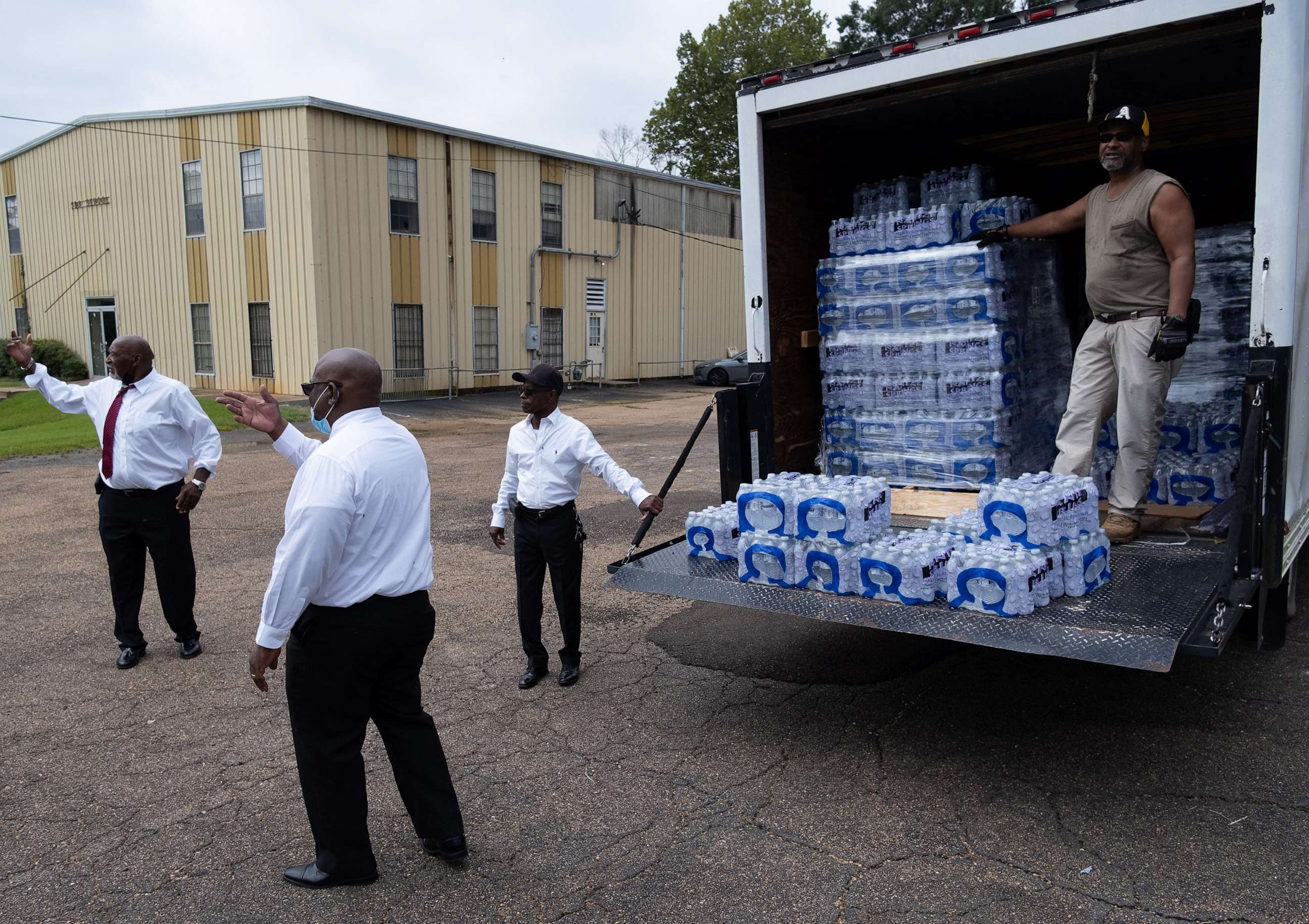 PHOTO: Members of Progressive Morningstar Baptist Church direct people to get bottled water following a Sunday morning service in Jackson, Miss., Sept. 4, 2022.