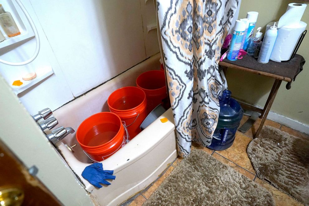 PHOTO: Doris Devine in Jackson, Miss., stores containers with potable water in her tub, Feb. 22, 2021. With no water pressure, the water will be used to flush the toilet.