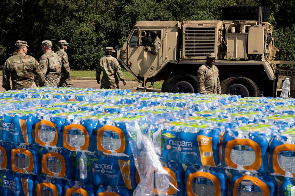 PHOTO: JACKSON, MS - SEPTEMBER 01: A truck carrying non-potable water arrives at Thomas Cardozo Middle School where personnel from the Mississippi National Guard were also handing out bottled water on September 01, 2022 in Jackson, Mississippi.