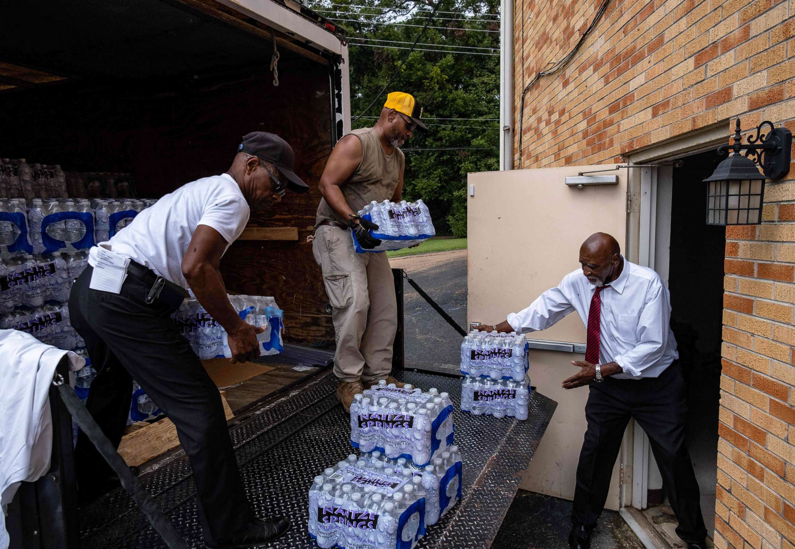PHOTO: Members of Progressive Morningstar Baptist Church move cases of water following a Sunday morning service in Jackson, Miss., on Sept. 4, 2022.