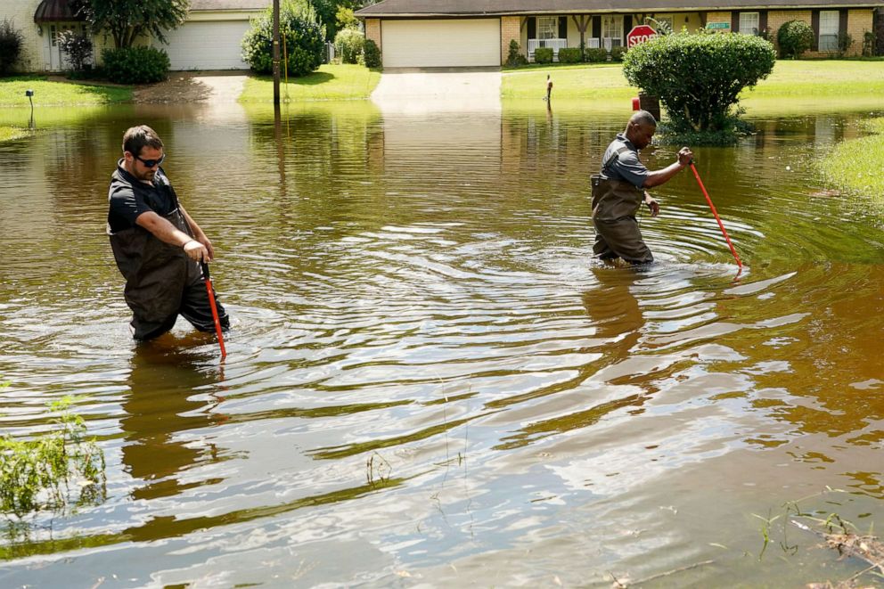 PHOTO: Hinds County Emergency Management Operations personnel wade through flood waters as they check water levels in neighborhoods that are near the Pearl River in northeast Jackson, Miss., Aug. 29, 2022. 