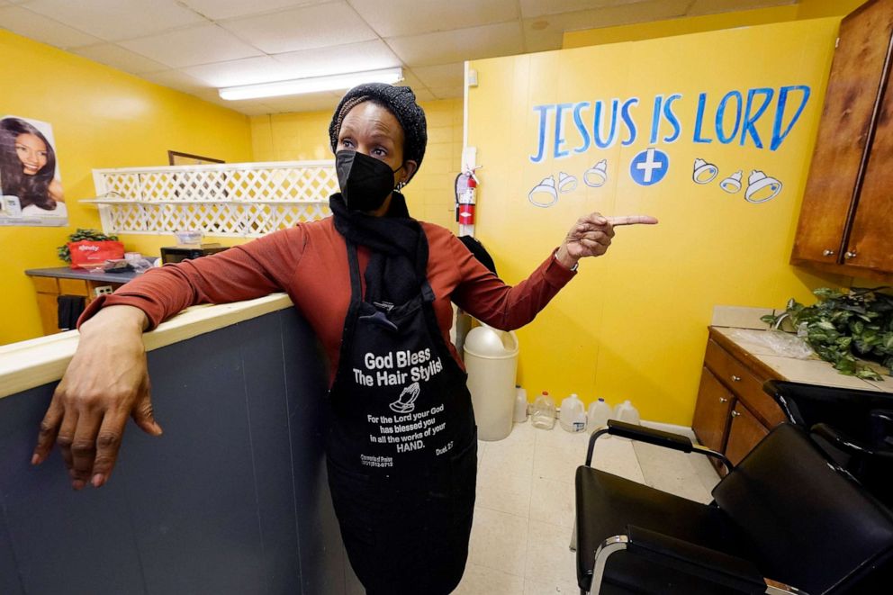 PHOTO: Belinda Smith, owner of Styles of Essence, a hair salon in south Jackson, Miss., talks about having bottled water available for rinsing clients hair because of the uncertainty of the city's water service, Jan. 26, 2022.