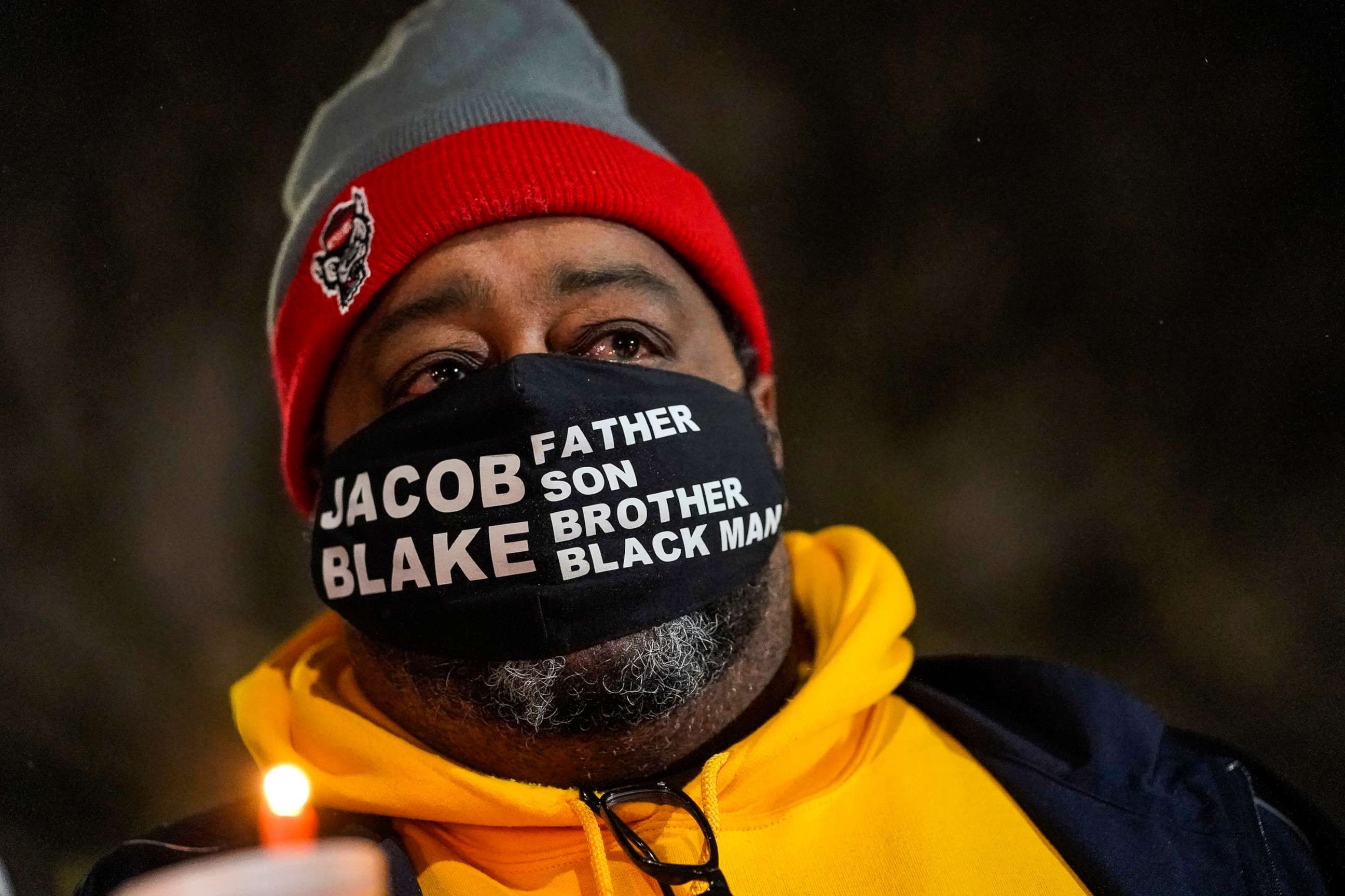 PHOTO: Jacob Blake Sr., father of Jacob Blake, holds a candle at a rally on Jan. 4, 2021, in Kenosha, Wis.