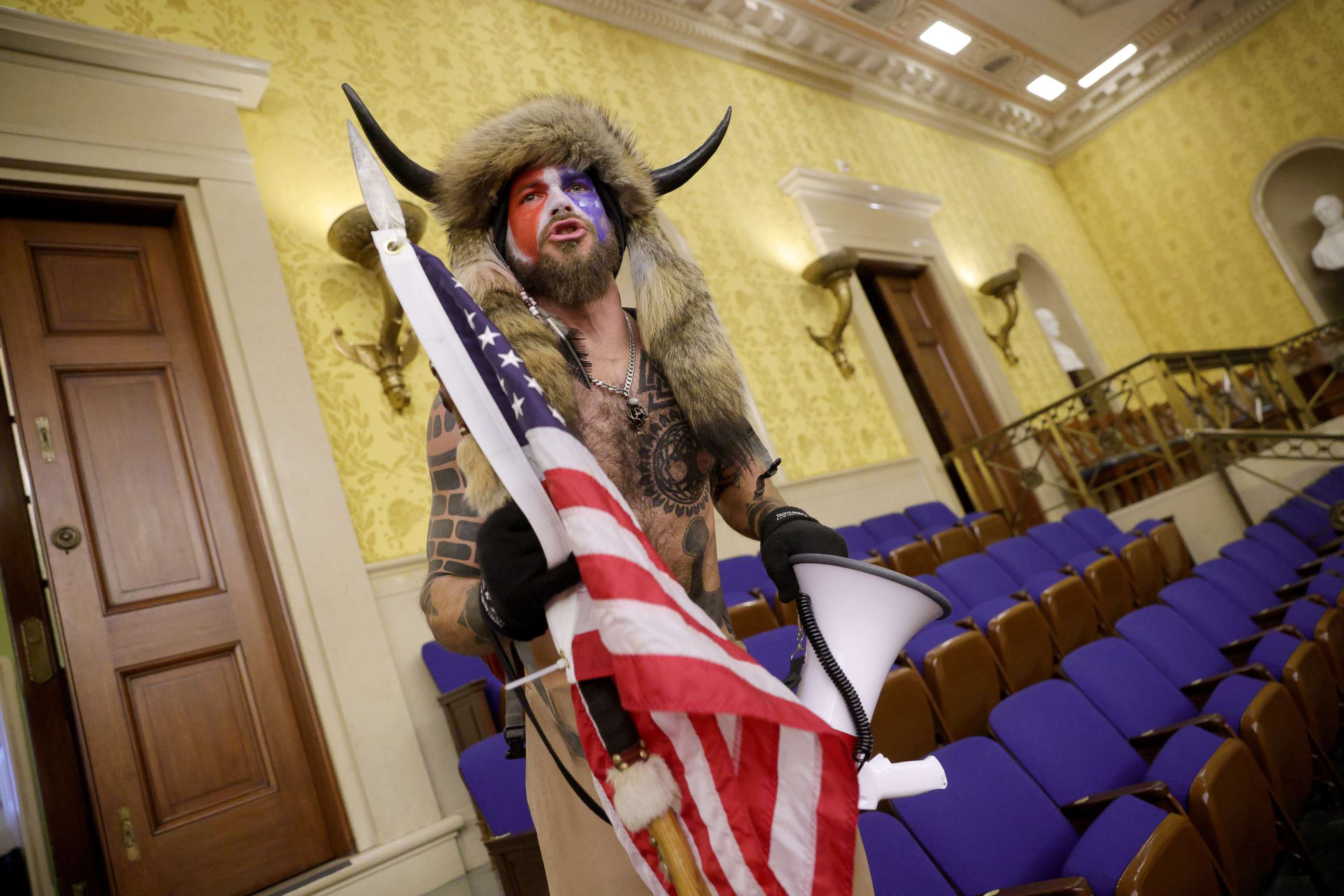 PHOTO: Jacob Chansley yells inside the Senate Chamber, Jan. 6, 2021, in Washington, D.C.