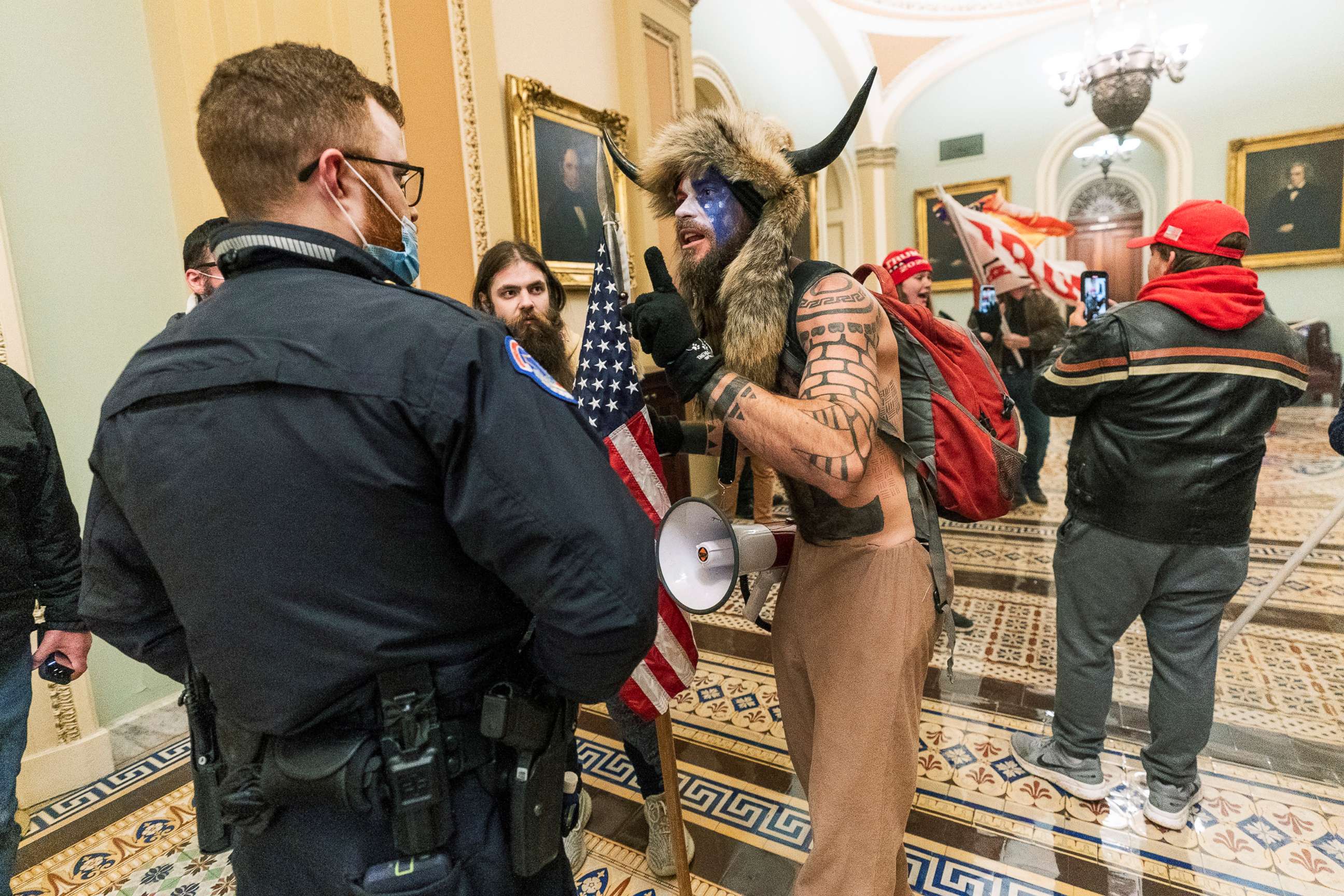 PHOTO: Jacob Chansley and other supporters of President Donald Trump are confronted by U.S. Capitol Police officers outside the Senate Chamber inside the Capitol in Washington, Jan. 6, 2021.