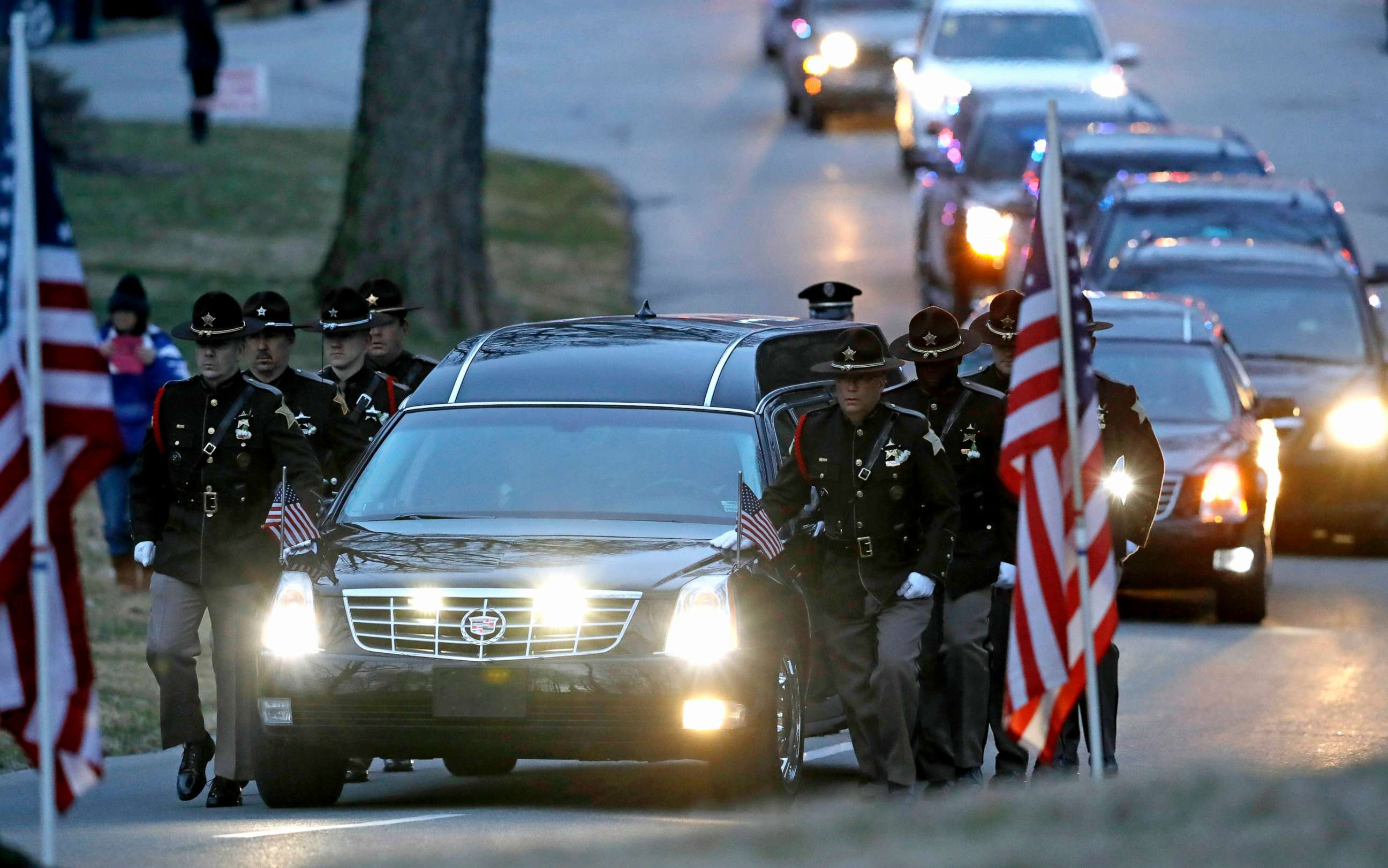PHOTO: The honor guard walks along the hearse carrying the casket of Boone County Sheriff's Deputy Jacob Pickett, March 9, 2018, in Indianapolis.