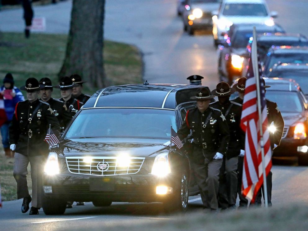 PHOTO: The honor guard walks along the hearse carrying the casket of Boone County Sheriffs Deputy Jacob Pickett, March 9, 2018, in Indianapolis.
