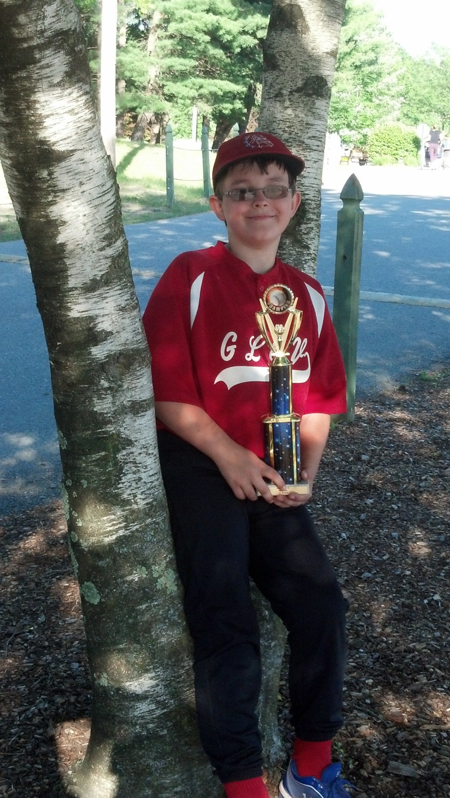 This photo provided by Richard Taras shows Jacobe Taras with a baseball championship trophy in 2014, a year before he committed suicide over school bullying in Moreau, N.Y.