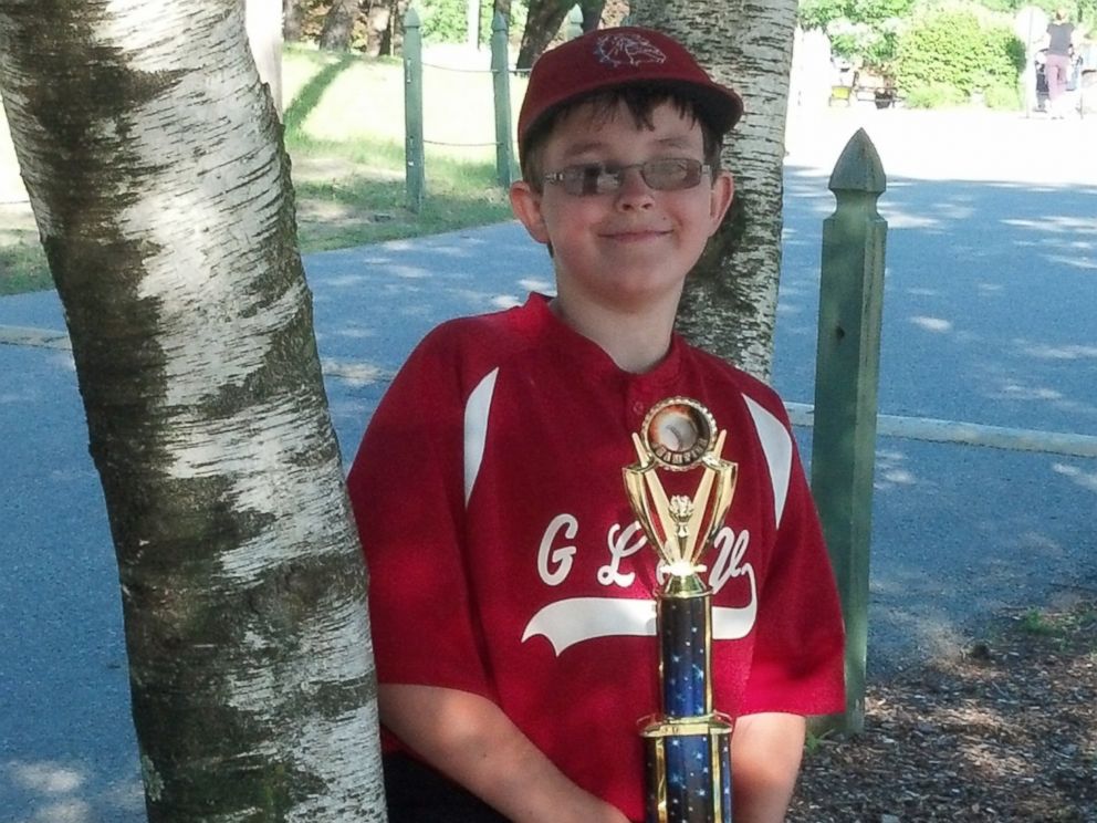 This photo provided by Richard Taras shows Jacobe Taras with a baseball championship trophy in 2014, a year before he committed suicide over school bullying in Moreau, N.Y.