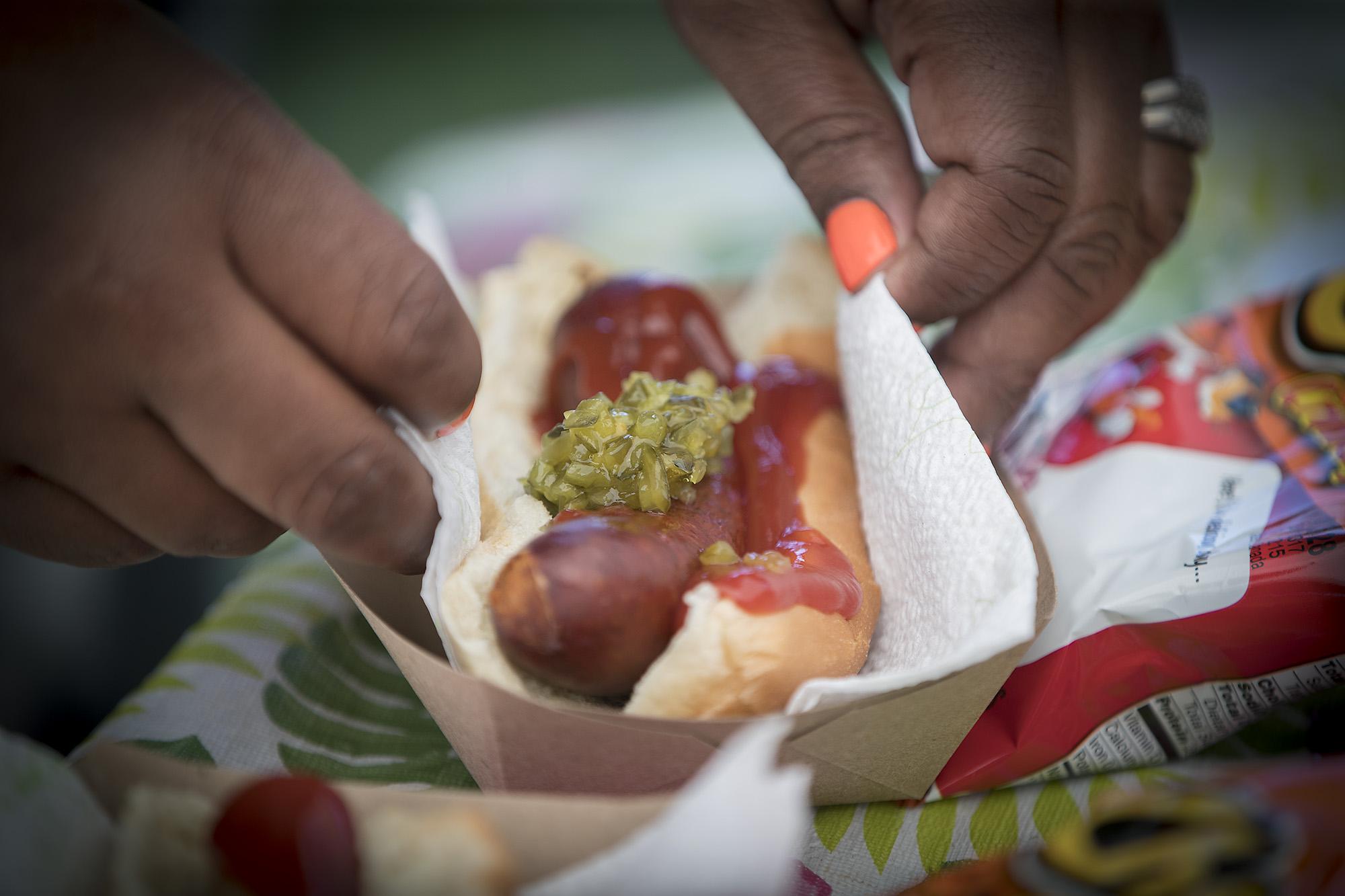 PHOTO: Thirteen-year-old hot dog entrepreneur Jaequan Faulkner serves up hot dogs at his hot dog stand, July 16, 2018 in Minneapolis, Minn.