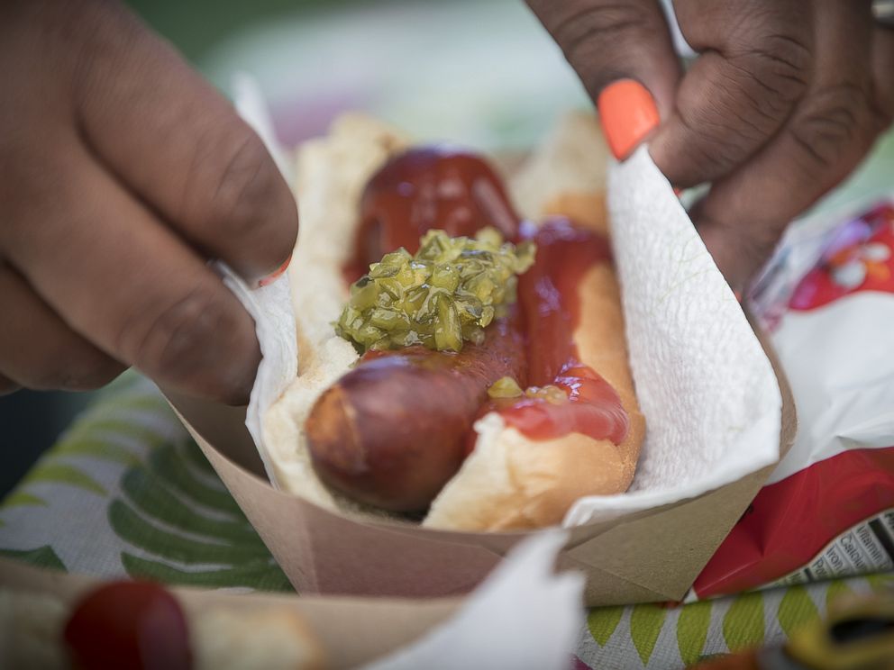 PHOTO: Thirteen-year-old hot dog entrepreneur Jaequan Faulkner serves up hot dogs at his hot dog stand, July 16, 2018 in Minneapolis, Minn.