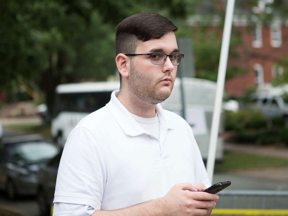PHOTO: In this Saturday, Aug. 12, 2017, photo, James Alex Fields Jr. stands on the sidewalk looking at the procession of the clergy as they gathered at McGaffey park, ahead of a rally in Charlottesville, Va.