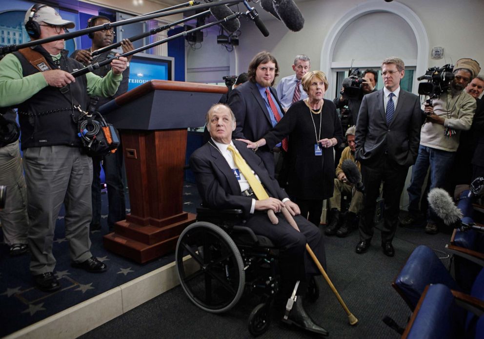 PHOTO: Former White House Press Secretary James Brady, center, visits the press briefing room that bears his name in the West Wing of the White House with current Press Secretary Jay Carney (3rd R) March 30, 2011 in Washington, DC.